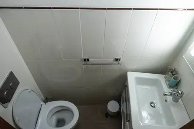 a small bathroom with a toilet and a sink at La Vite 94 in Rome