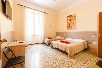 a hotel room with two beds and a window at Furio Camillo in Rome