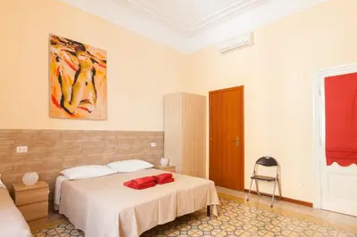 a bedroom with a bed and a painting on the wall at Furio Camillo in Rome