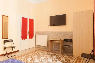 a living room with a television on the wall at Furio Camillo in Rome