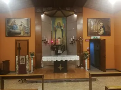 an altar in a church with paintings on the walls at Casa per Ferie Suore Domenicane in Rome