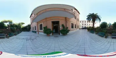 a building with a courtyard with benches in front of it at Casa per Ferie Suore Domenicane in Rome