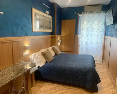 a bedroom with a bed in a blue room at B&B Acasadibarbara in Rome