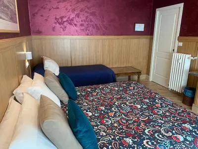 a bedroom with a large bed with a blue bedspread at B&B Acasadibarbara in Rome