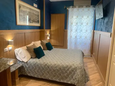 a bedroom with a bed with blue walls at B&B Acasadibarbara in Rome