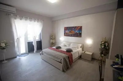 a bedroom with a bed and a painting on the wall at Rooms Monteverde 2 in Rome
