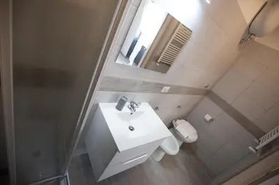 a bathroom with a sink and a toilet and a mirror at Rooms Monteverde 2 in Rome