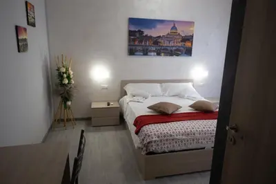 a bedroom with a bed with a painting on the wall at Rooms Monteverde 2 in Rome