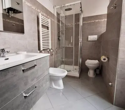 a bathroom with a sink and a toilet and a shower at Residenza San Pietro in Rome