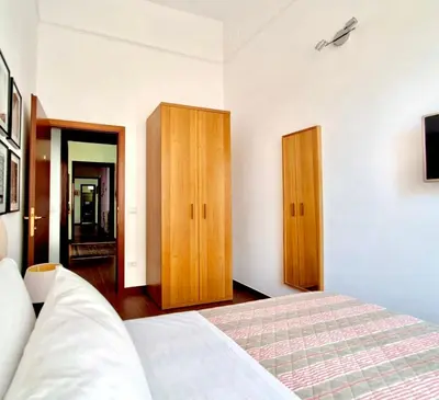 a bedroom with a bed and two wooden cabinets at Residenza San Pietro in Rome