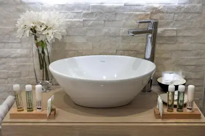 a bathroom with a large white bowl sink on a table at Barcaccia Luxury Suites in Rome