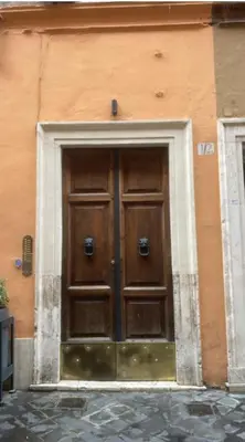 a large wooden door on the side of a building at Barcaccia Luxury Suites in Rome