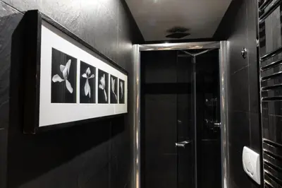 a bathroom with a picture of flowers on the wall at Barcaccia Luxury Suites in Rome