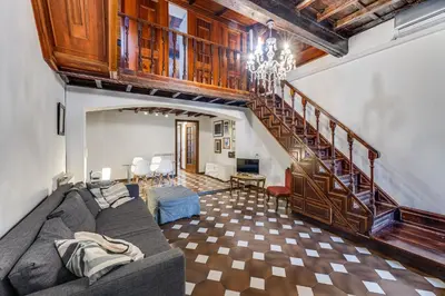 a living room with a couch and a staircase at Linhouse in Rome