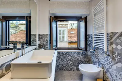 a bathroom with a tub and a sink and a toilet at Linhouse in Rome