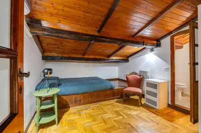 a bedroom with a bed and a desk and a chair at Linhouse in Rome