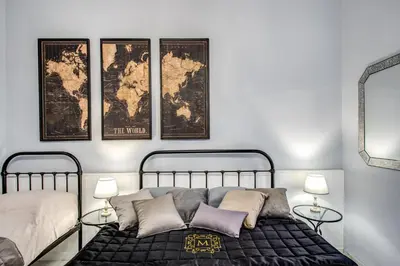 a bedroom with two beds and a map on the wall at Ripetta Miracle Suite in Rome