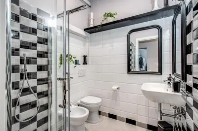 a bathroom with a toilet and a sink and a mirror at Ripetta Miracle Suite in Rome