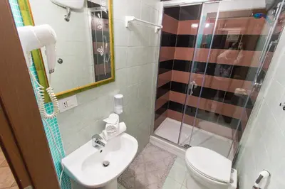 a bathroom with a toilet and a sink and a shower at Aquarium Termini in Rome