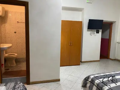 a room with a bathroom with a bed and a toilet at Aquarium Termini in Rome
