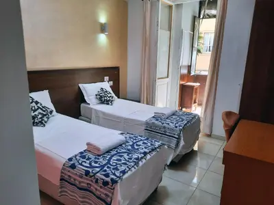 a hotel room with two beds and a window at Aquarium Termini in Rome