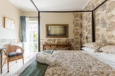 a bedroom with a large bed and a mirror at B&B Abbraccia Morfeo in Rome