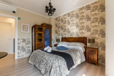 a bedroom with two beds and a chandelier at B&B Abbraccia Morfeo in Rome