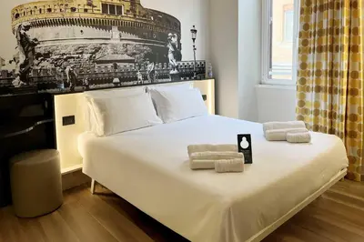 a bedroom with a bed with towels on it at B&B Hotel Roma San Lorenzo Termini in Rome