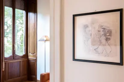a drawing of a woman on a wall next to a door at Flat Three in Rome