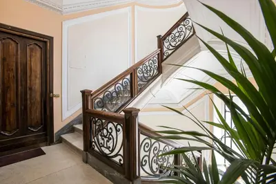 a staircase in a house with a plant at Flat Three in Rome