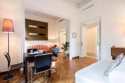 a living room with a white couch and a desk at Flat Three in Rome