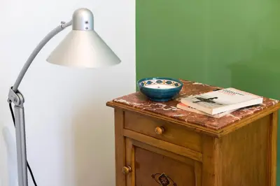 a table with a lamp and a bowl on it at Flat Three in Rome