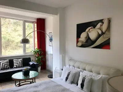 a bedroom with a bed and a table and a window at Gallery Guesthouse in Rome
