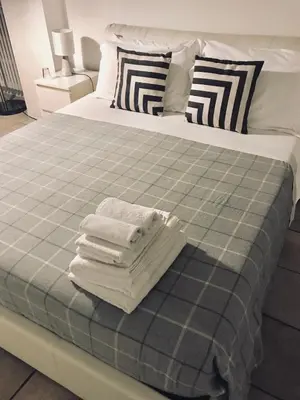a bed with towels stacked on top of it at Gallery Guesthouse in Rome