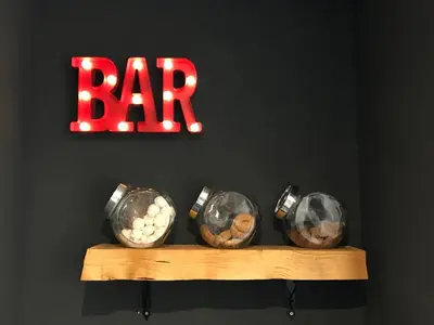 a group of four balls on a shelf with a bar sign at Gallery Guesthouse in Rome