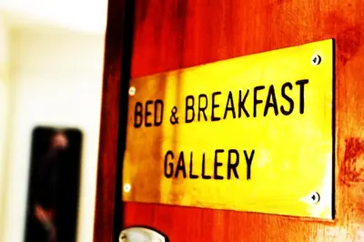 a yellow sign on a door with the words bed and breakfast gallery at Gallery Guesthouse in Rome