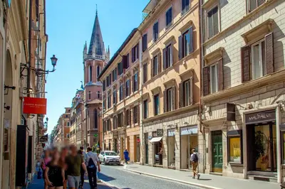 a group of people walking down a street with buildings at Piazza di Spagna Moda Luxury Apartment in Rome
