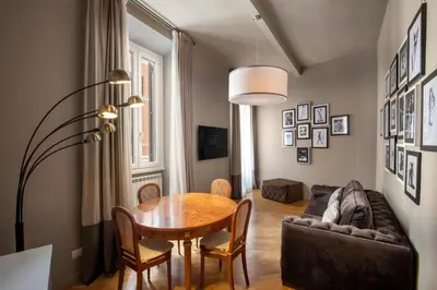 a living room with a table and a couch at Piazza di Spagna Moda Luxury Apartment in Rome