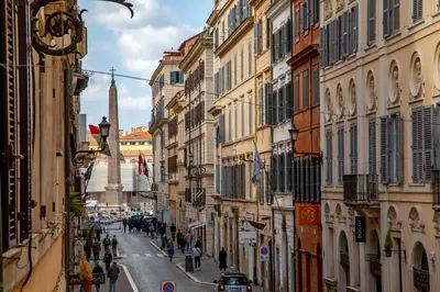 a group of people walking down a street with buildings at Piazza di Spagna Moda Luxury Apartment in Rome