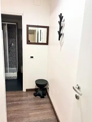 a bathroom with a black stool and a mirror at Core De Roma Suites in Rome