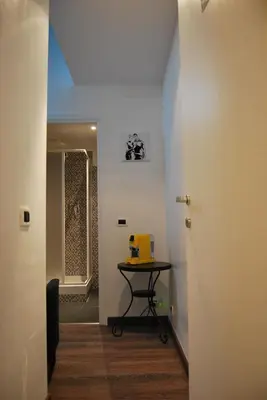 a hallway with a table with a yellow object on it at Core De Roma Suites in Rome