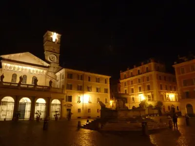 a large building with a clock tower at night at Core De Roma Suites in Rome
