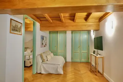 a living room with green doors and a couch at Maddalena 6 - Pantheon in Rome