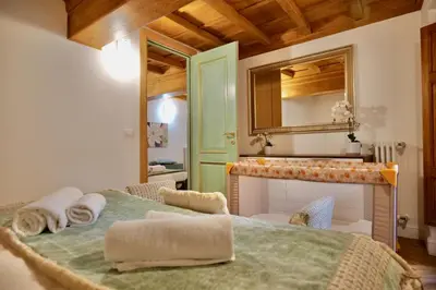 a bedroom with a bed with a fireplace and a mirror at Maddalena 6 - Pantheon in Rome