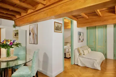 a living room with a glass table and a couch at Maddalena 6 - Pantheon in Rome