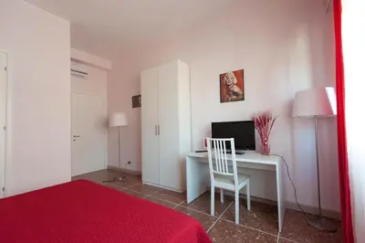 a bedroom with a desk with a computer and a chair at Parco Delle Valli in Rome