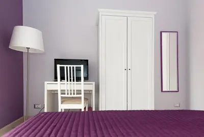a bedroom with a bed and a desk and a chair at Parco Delle Valli in Rome