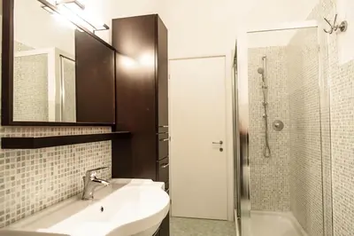 a white bathroom with a sink and a shower at Parco Delle Valli in Rome