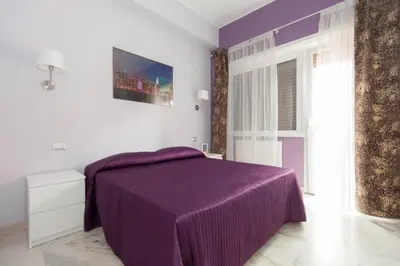 a bedroom with a purple bed with a purple blanket at Parco Delle Valli in Rome