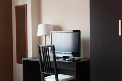a desk with a computer monitor and a chair at Parco Delle Valli in Rome